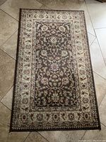 Full view of 3x5 Classic Agra rug with floral and scroll patterns in brown, cream, gold, and burgundy colors on tile floor.