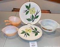 Overall view showing Fire King and Joni Dixie Dogwood dinnerware pieces: casserole, chili bowls, and two floral dinner plates.