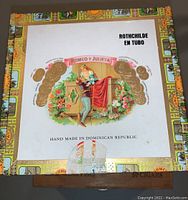 Closed top view of Romeo y Julieta Rothchilde wooden cigar box featuring colorful vintage artwork and Latin American design elements.