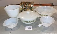Full lot including nesting bowls, casserole dish, handled bowl, and recipe cardholder with multicolor flower power print