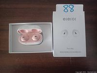Eleror Pro-X6s mini wireless earbuds in pink inside charging case, with original box beside it.
