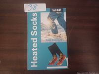 Front view of the LHZ Heated Socks box showing product name and images.