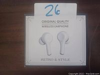 Front view of a white square box containing a pair of original quality wireless earphones, with text 'Original Quality Wireless Earphone Retro & Style' on it.