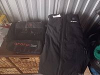 Photo of the Ororo heated vest and carrying bag showing brand name on both items.