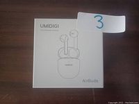 Front view of the Umidigi Airbuds retail packaging showing earbuds and charging case illustration.