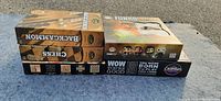 Three boxed games stacked side by side showing Cranium Chess and Backgammon, Funko Pop FunkoVerse Harry Potter game