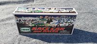 Photo showing front and top side of original Hess Race Car and Racer 2009 box with toy car images and branding