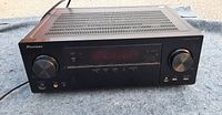 Front-angle view of the black Pioneer VSX-1028 AV receiver showing volume and control knobs, display panel and front inputs.