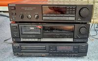 Three stacked Sony audio components: top unit STR AV 210 receiver, middle TC FX 110 cassette player, bottom CDP 550 CD player. Black color with front displays, knobs, and buttons visible.