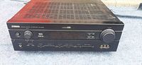Top and front view of Yamaha AV Receiver HTR-5650 showing black finish, ventilation grills, and front controls including knobs and input ports.