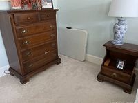 Chest of drawers and nightstand side by side showing finish and hardware
