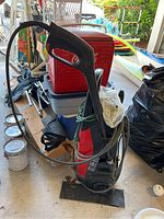 Full view of Husky power washer showing power cord wrapped around body, spray handle, and unit body color.
