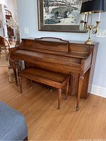 Full view of the Kohler & Campbell upright piano with the bench underneath, showing overall condition and wood finish.