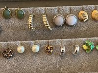 Close-up of assorted earrings laid on fabric