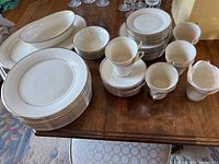 Full overview of plates, cups, saucers, bowls and platters arranged on table
