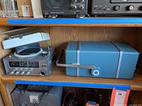 View of Maricom All Transistor Direction Finder on left with frequency display, knobs, and directional dial; Oscilloscope Type 422 on right