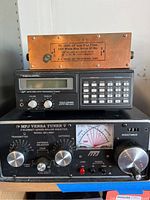 Front view showing stacked devices: RL Drake TV-1000 low pass filter on top, Realistic PRO-2022 scanner in middle, and MFJ Versa Tuner MFJ-989C at bottom.