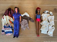 Full lot image showing Ken and Julia dolls with multiple clothing items including nurse outfits and casual wear.