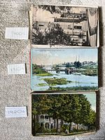 Three stacks of postcards labeled by decade: 1900s, 1910s, 1920s, each showing typical fronts of vintage cards with architectural and scenic imagery.