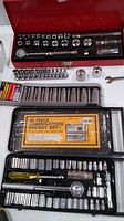 Photo of socket wrench sets: red metal case Husky set, black plastic case 40-piece combination socket set with label, and Craftsman sockets.