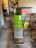 Full front view of the Earthwise chipper shredder showing green upper part with handle, gray lower front panel, wheels, and base.