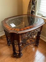 Front and top view of solid wood end table with glass inset over wrought iron design