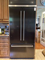 Full front view of fridge in kitchen setting