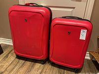 Front view of the pair of red Heys luggage, showing the brand logos and overall condition.