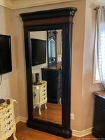 Front view of closed mirror armoire showing overall condition and proportions