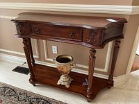 Front view of console table showing drawer front, ring pull handles and lower shelf