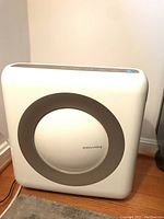 Front view of Coway air purifier showing the circular design and logo.