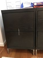 Front view of the two drawer file cabinet showing the wood grain surface and two metal drawer handles.