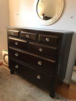 Front and angled views of dark brown Martha Stewart dresser with six drawers and silver knobs, showing the dresser's size and style.