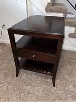 Front view of Woodbridge side table showing drawer and shelves