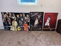 Overall view of the lot showing three items: one signed Obama inauguration painting on canvas and two framed basketball posters.