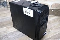 Side angle of black Dell desktop computer tower with attached power cable, label 'Lot #119' on side panel.