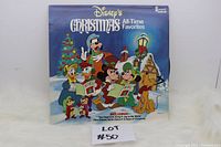 Front cover of Disney's Christmas All-Time Favorites vinyl record featuring Disney characters in Christmas setting.