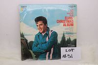 Front cover of Elvis' Christmas Album vinyl record sealed in plastic with visible edge wear on the sleeve.