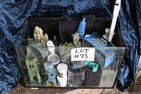 Photo of fish tank filled with various aquarium accessories including decorations and water treatment bottles