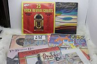 Photo showing front cover of 25 Rock Revival Greats, Carpenters album and portion of other records in the lot