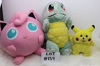 Photo showing the lot of three Pokemon plush toys: Jigglypuff, Squirtle, and Pikachu.