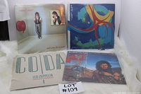 Four vinyl LP albums by Robert Plant and Led Zeppelin laid out together on a white surface.