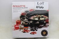 Front view of sealed roulette drinking game box showing game wheel, shot glasses with colored liquids, and poker chips.