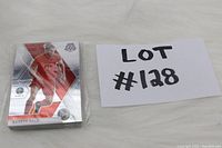 Photo showing stack of soccer player cards including a Harry Kane card with silver metallic design and red uniform.