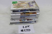 Stack of six Nintendo Wii game cases with titles visible, demonstrating lot assortment.