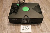 Front view showing entire Xbox console with power cable and label with lot number.