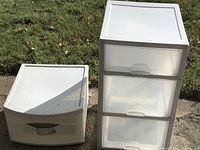 Two plastic drawer units outside on pavement and grass background, one single drawer unit on left, three drawer unit on right
