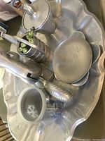Top-down view of entire vintage aluminum nut cracker set on scalloped tray including nut cracker, sugar bowl with lid and spoon, fruit picker, and small bowl.