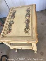 Full view of the table focusing on the hand-painted floral top design.