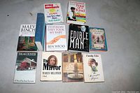 Photo showing 10 of the 11 novels, arranged flat with covers visible for identification.